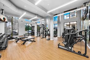 Palmetto Bay apartment for rent - a gym with weights and other exercise equipment on a wooden floor