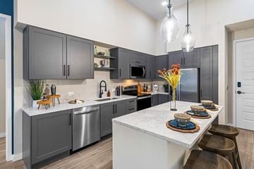 Palmetto Bay apartment for rent - a kitchen with gray cabinets and a white counter top