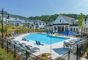 Cartersville apartment for rent - a swimming pool with chairs and umbrellas in front of a building