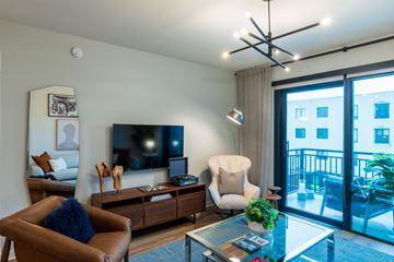 Atlanta apartment for rent - A living room with a brown leather chair and a glass coffee table.