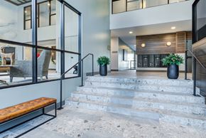 Milwaukee apartment for rent - A modern interior with a staircase leading to a lower level.