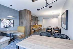 Milwaukee apartment for rent - A modern dining area with a long table and chairs.