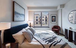 Aurora apartment for rent - a bedroom with a bed with pillows and a blanket
