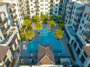 Palmetto Bay apartment for rent - a view of the pool at an apartment building with palm trees