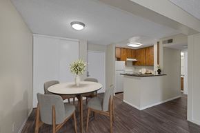 Las Vegas apartment for rent - Dining room and kitchen with wood-style vinyl plank flooring.