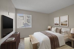 Las Vegas apartment for rent - Carpeted bedroom with virtually staged furniture and window.