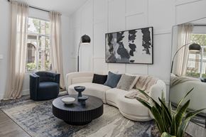 Las Vegas apartment for rent - Modern living room with wood-style vinyl plank flooring, large windows, and wall accents.