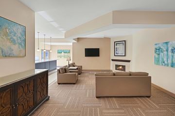 Las Vegas apartment for rent - A living room with a fireplace and a painting on the wall.