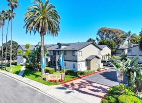 Carlsbad apartment for rent - a row of houses on a street with palm trees