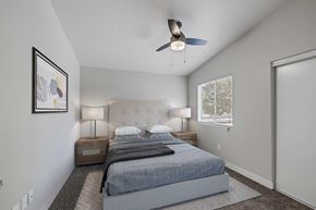 Las Vegas apartment for rent - A bedroom with a bed, two lamps, and a ceiling fan.