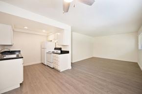 Carlsbad apartment for rent - an empty kitchen and living room with white appliances and wood flooring