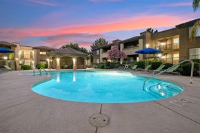 Tucson apartment for rent - A swimming pool in a residential area surrounded by houses.