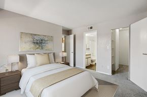 Mesa apartment for rent - A bedroom with a large bed and a painting on the wall.