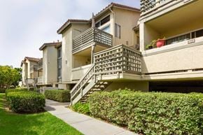 Laguna Niguel apartment for rent - Apartment building with a green hedge in front.