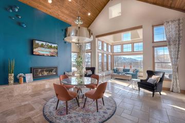 Reno apartment for rent - A living room with a fireplace and a painting of a pool.