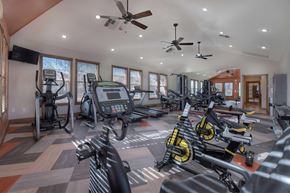 Reno apartment for rent - A gym with a variety of exercise equipment including treadmills, stationary bikes, and elliptical machines.