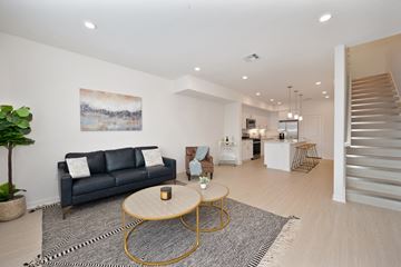 Montebello apartment for rent - A living room with a grey couch and a painting on the wall.
