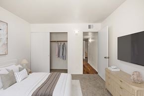 Kingman apartment for rent - Carpeted bedroom with view to hallway and sliding door closet.