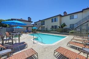 Carlsbad apartment for rent - The swimming pool with chairs and umbrellas.