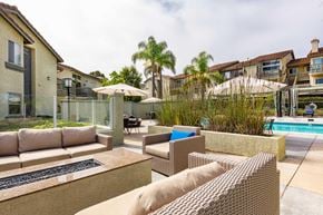 Laguna Niguel apartment for rent - A patio with a couch, chairs, and a pool.