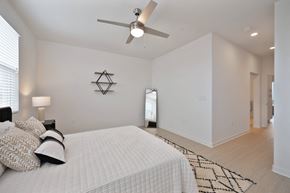 Montebello apartment for rent - a white bedroom with a large bed and a ceiling fan
