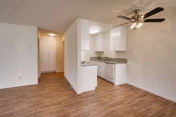 La Mesa apartment for rent - A kitchen with white cabinets and a ceiling fan.