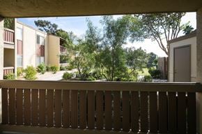 La Mesa apartment for rent - Balcony overlooking courtyard with trees and landscaping.