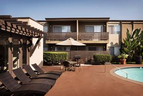 La Mesa apartment for rent - Sundeck with poolside, lounge chairs, table, and community exterior.