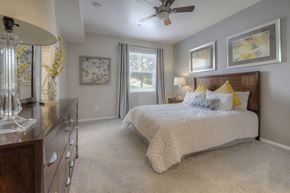 Reno apartment for rent - A bedroom with a large bed and a ceiling fan.