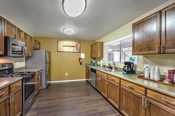 Henderson apartment for rent - A kitchen with wooden cabinets and a stove top oven.