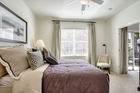 Las Vegas apartment for rent - Carpeted bedroom with ceiling fan and window with lots of natural light.