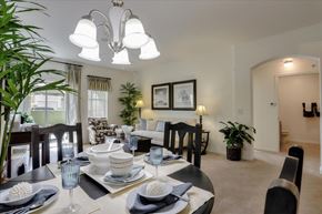 Las Vegas apartment for rent - Carpeted dining room view with overhead light and view to sliding door balcony and interior hallway.