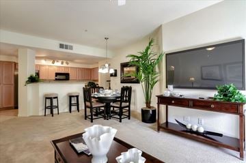 Las Vegas apartment for rent - A living room with a dining table and chairs.