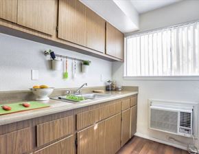 Las Vegas apartment for rent - Shared kitchen with wood cabinets and window.