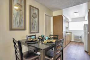 Las Vegas apartment for rent - Shared living room and dining room with table, chairs, and view to kitchen.