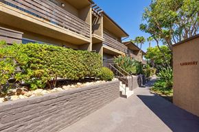 La Mesa apartment for rent - Exterior walkway with shrubs and brick exterior.