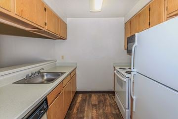 Des Moines apartment for rent - A kitchen with a white refrigerator, sink, and stove.