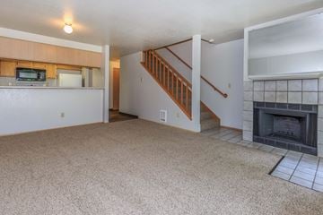 Des Moines apartment for rent - A living room with a fireplace and a staircase.