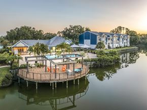Tampa apartment for rent - A house with a deck over water and a swimming pool.