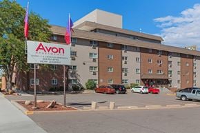 Denver apartment for rent - A parking lot in front of a multi-story apartment building with a sign that says Avon Apartments.