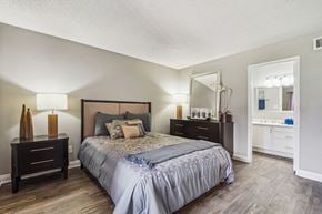 Mesa apartment for rent - A bedroom with a large bed and a mirror on the wall.