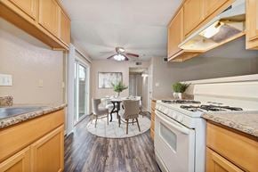 Modesto apartment for rent - A kitchen with wooden cabinets and a white stove top oven.
