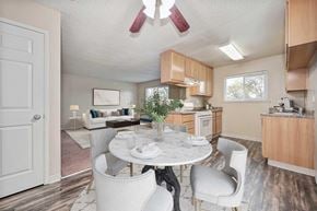 Modesto apartment for rent - A white dining table with chairs and a potted plant in a kitchen.