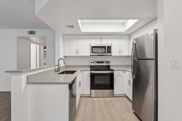 Glendale apartment for rent - A modern kitchen with stainless steel appliances and white cabinetry.