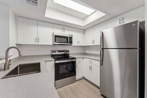 Glendale apartment for rent - A modern kitchen with stainless steel appliances and white cabinets.