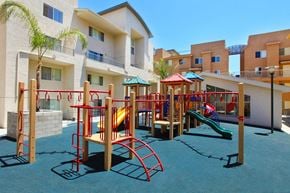 San Diego townhouse for rent - Community playground with light gray and tan building exterior in background.