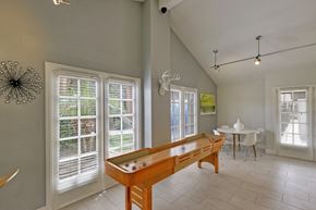 Phoenix apartment for rent - A pool table in a room with a television mounted on the wall.