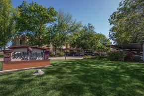 Coalinga apartment for rent - A sign that says "Cooling Station" is in front of a grassy area.