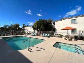 Phoenix apartment for rent - A pool area with a large swimming pool and a smaller hot tub.