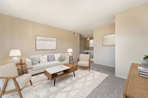 Modesto apartment for rent - A living room with carpet, a couch, 2 chairs, a rug, and a coffee table.